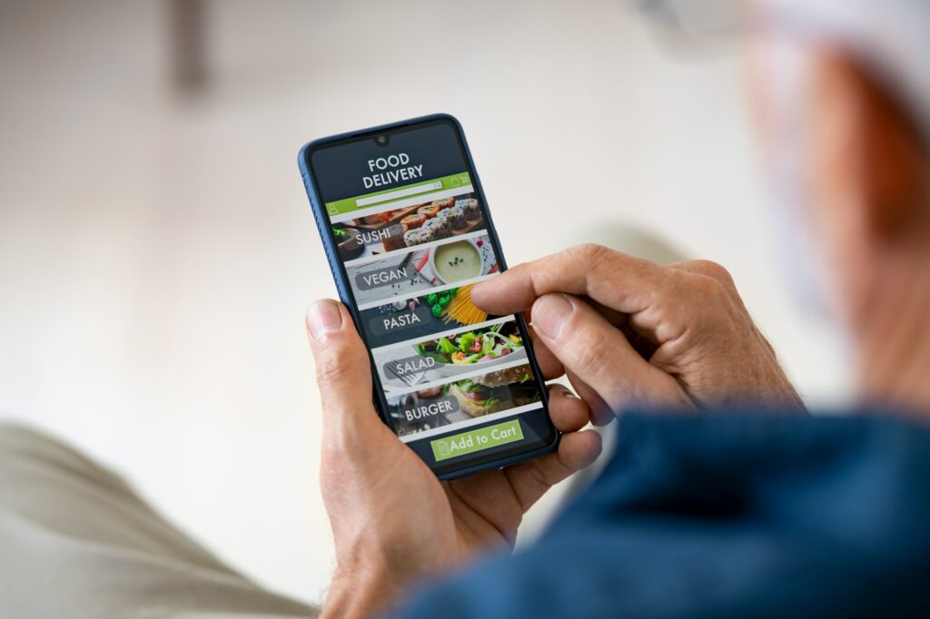 Man using mobile app to order delivery food